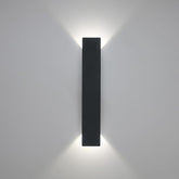 Vertical wall sconce emitting up and down lighting